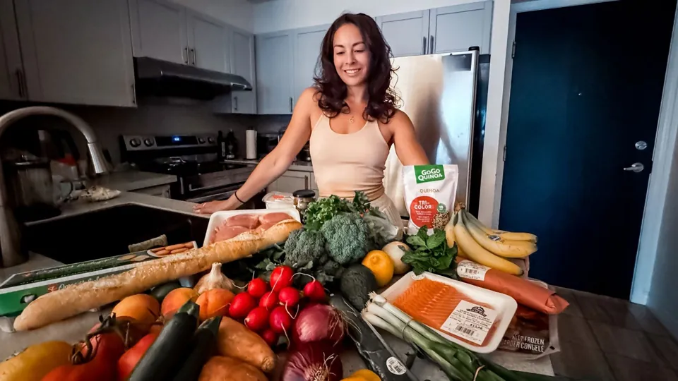 Beverley Cheng in her kitchen with fresh vegetables and groceries